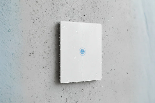 IP65 waterproof smart switch installed on outdoor wall with water droplets showing weatherproof power switch for outdoor use in Pakistan